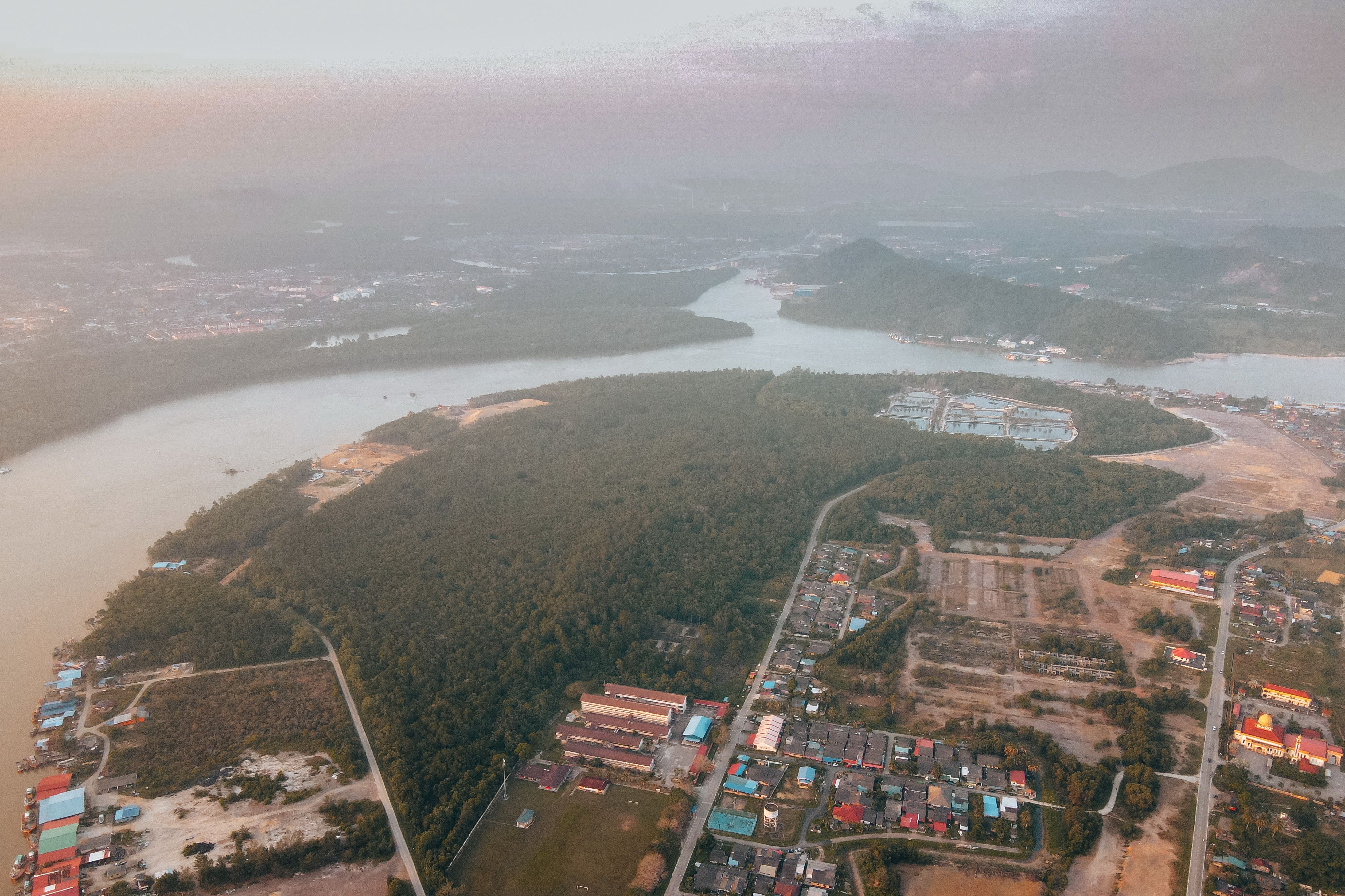 Aerial view of Chukai, Terengganu, showing homes, the Kemaman River, and surrounding green landscapes